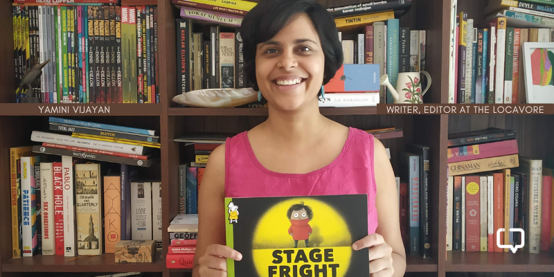 photo of yamini vijayan, a woman, holding a book. She is the editor of the food stories venture, The Locavore